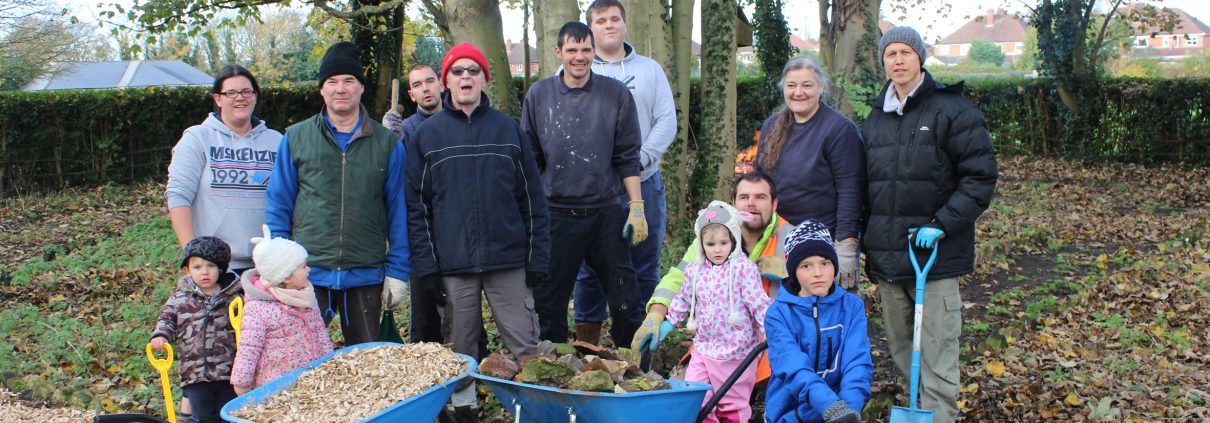 A group volunteers stand in the Centenary Garden at Boultham Park.