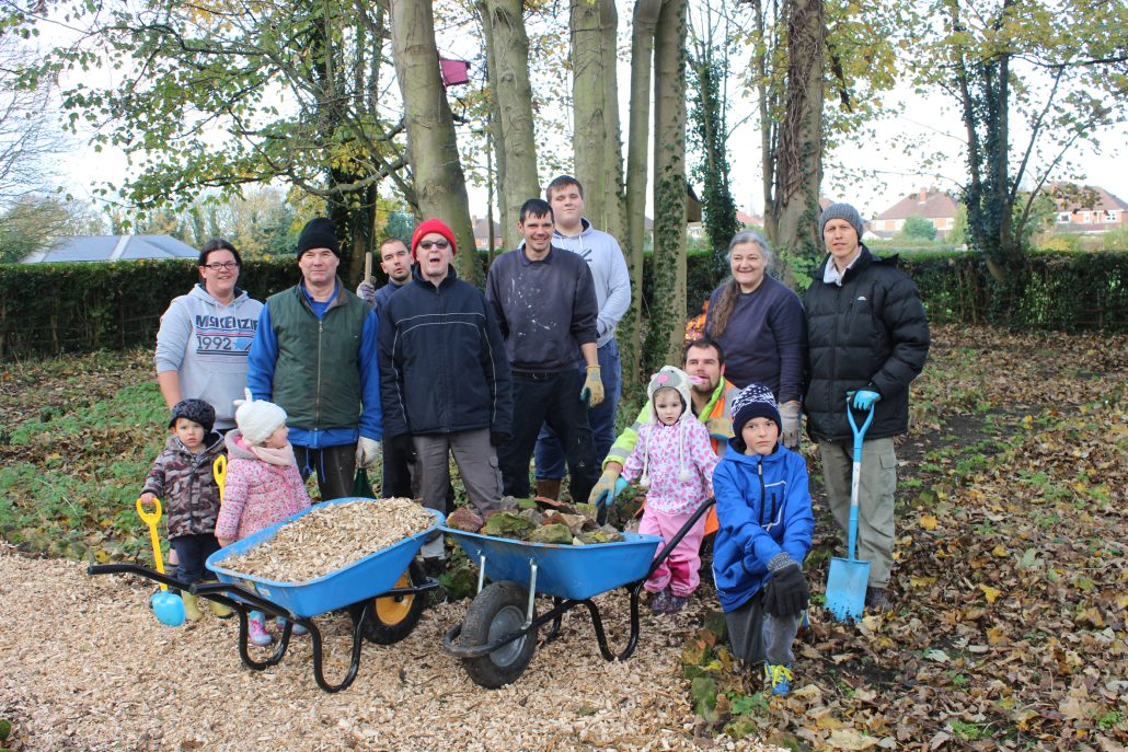 A group volunteers stand in the Centenary Garden at Boultham Park.